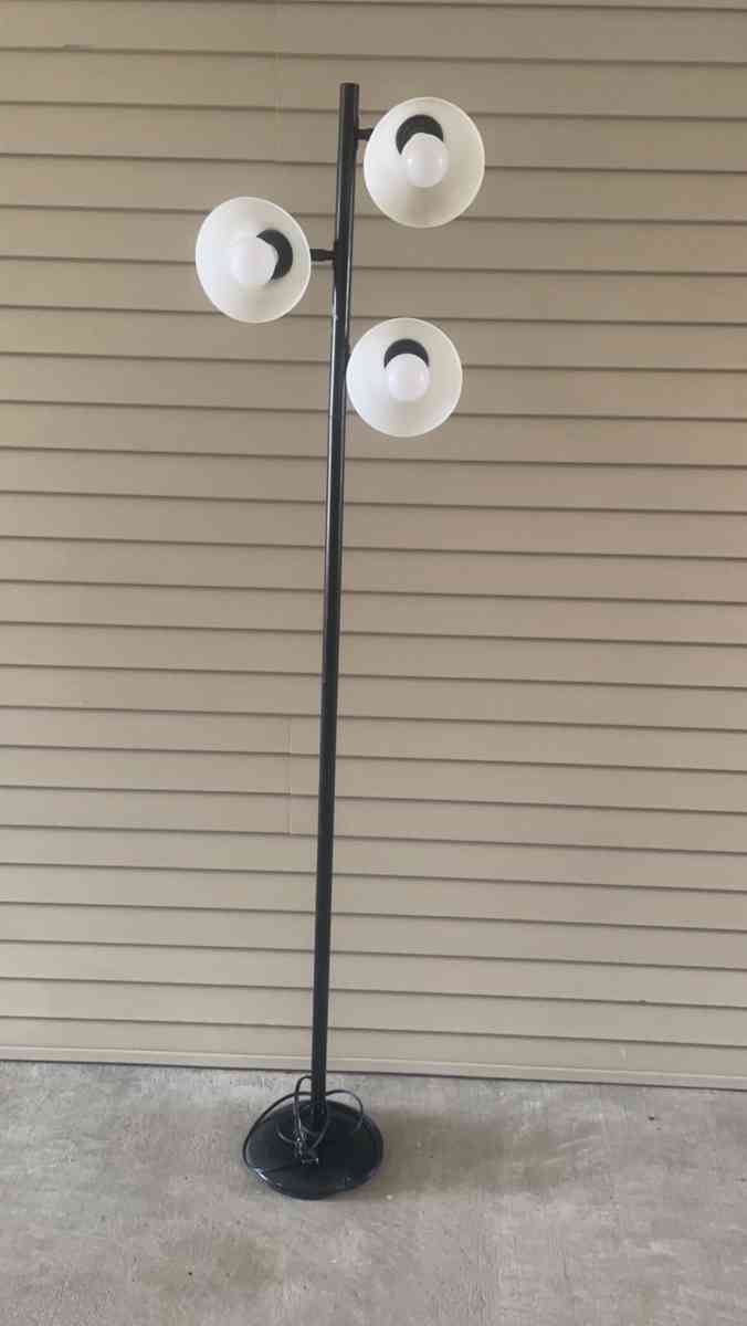 tall black lamp with three head lights