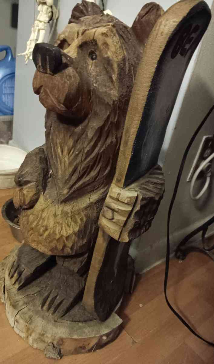 Bear holding surfboard that says BEAR EXTREME