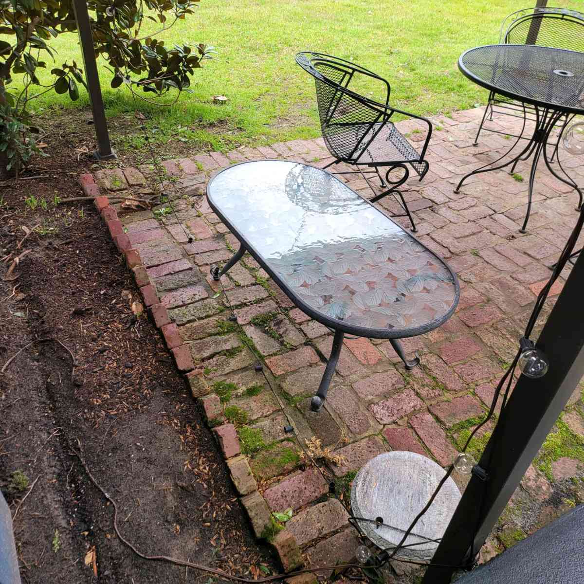 Oval outdoor glass coffee table with metal trim - Shreveport, Louisiana