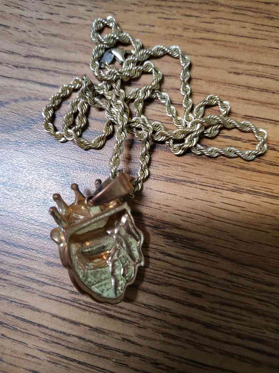This is a goldtoned lion head pendant with a crown - Saint Joseph, Missouri - FleaMarketBay