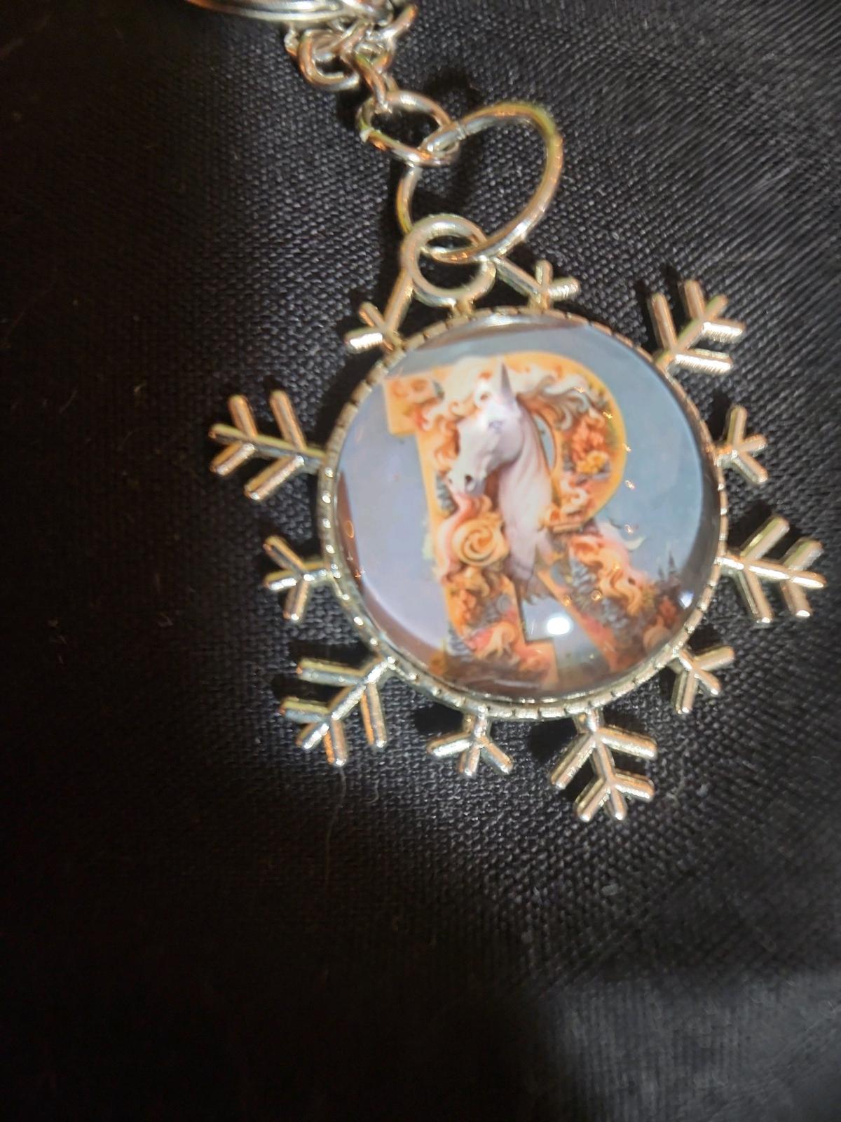 a snowflake pendant with a unicorn and the letter R - Romney, West Virginia - FleaMarketBay